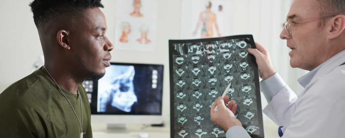 doctor explaining cause of back pain e1699554786491