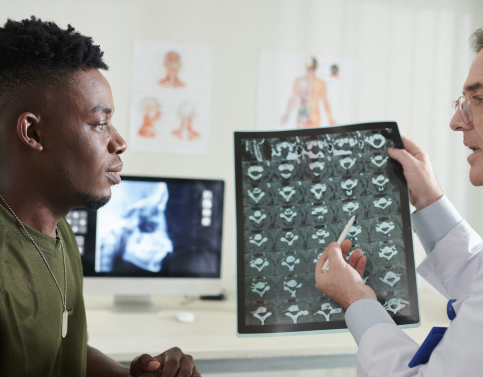 doctor explaining cause of back pain e1699554786491