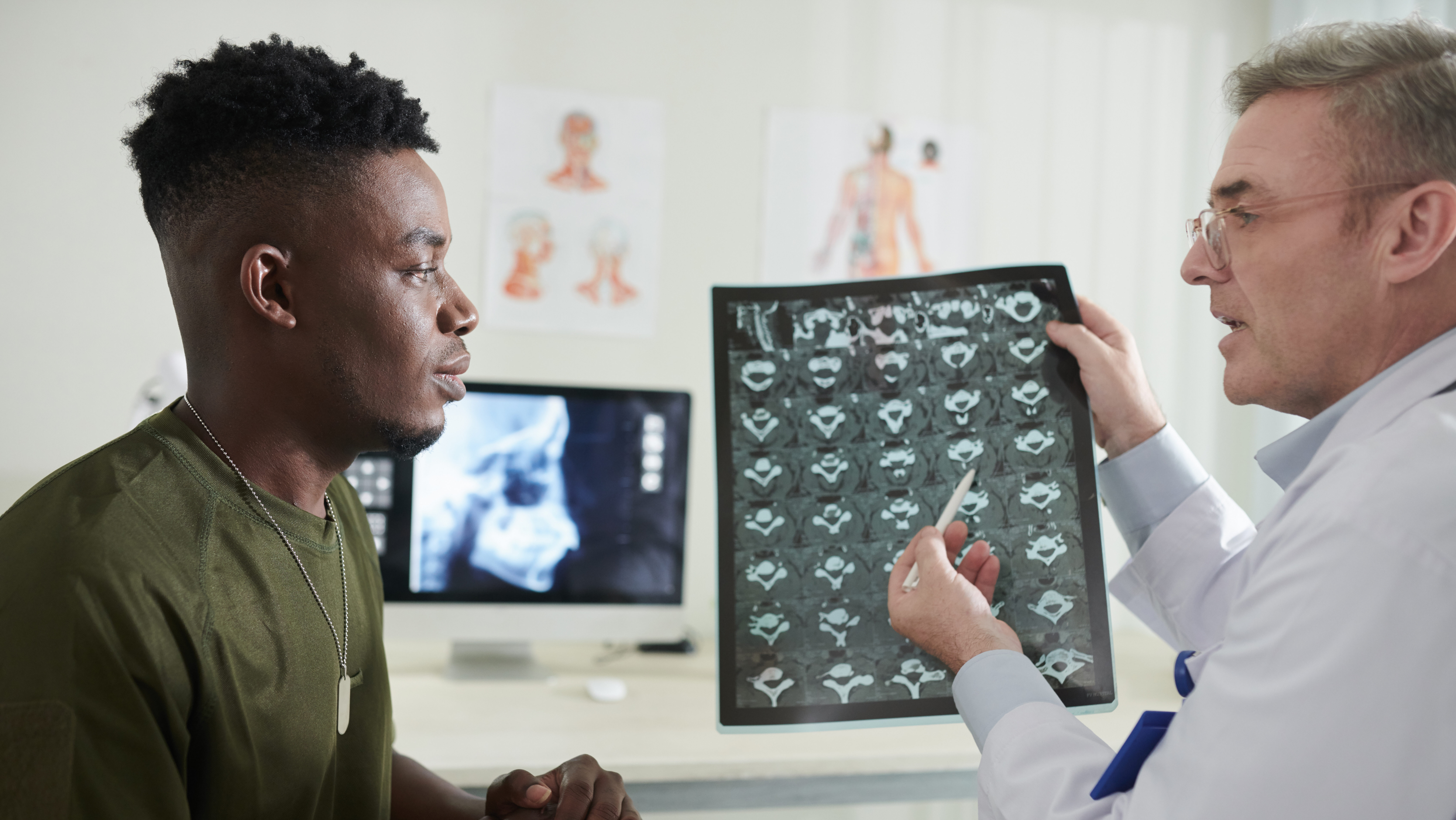 doctor explaining cause of back pain e1699554786491