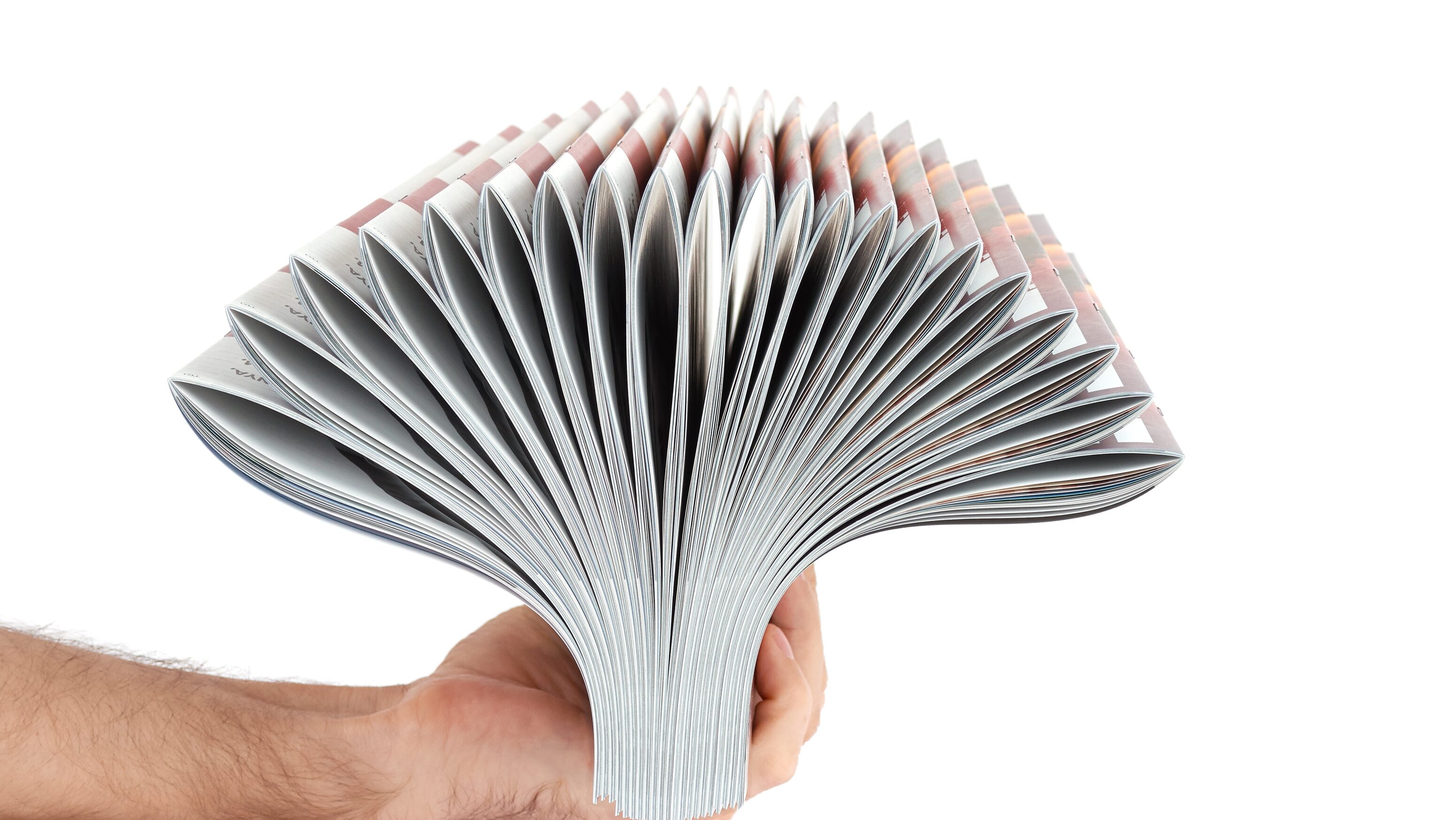 pile of magazines in hand e1699544096954