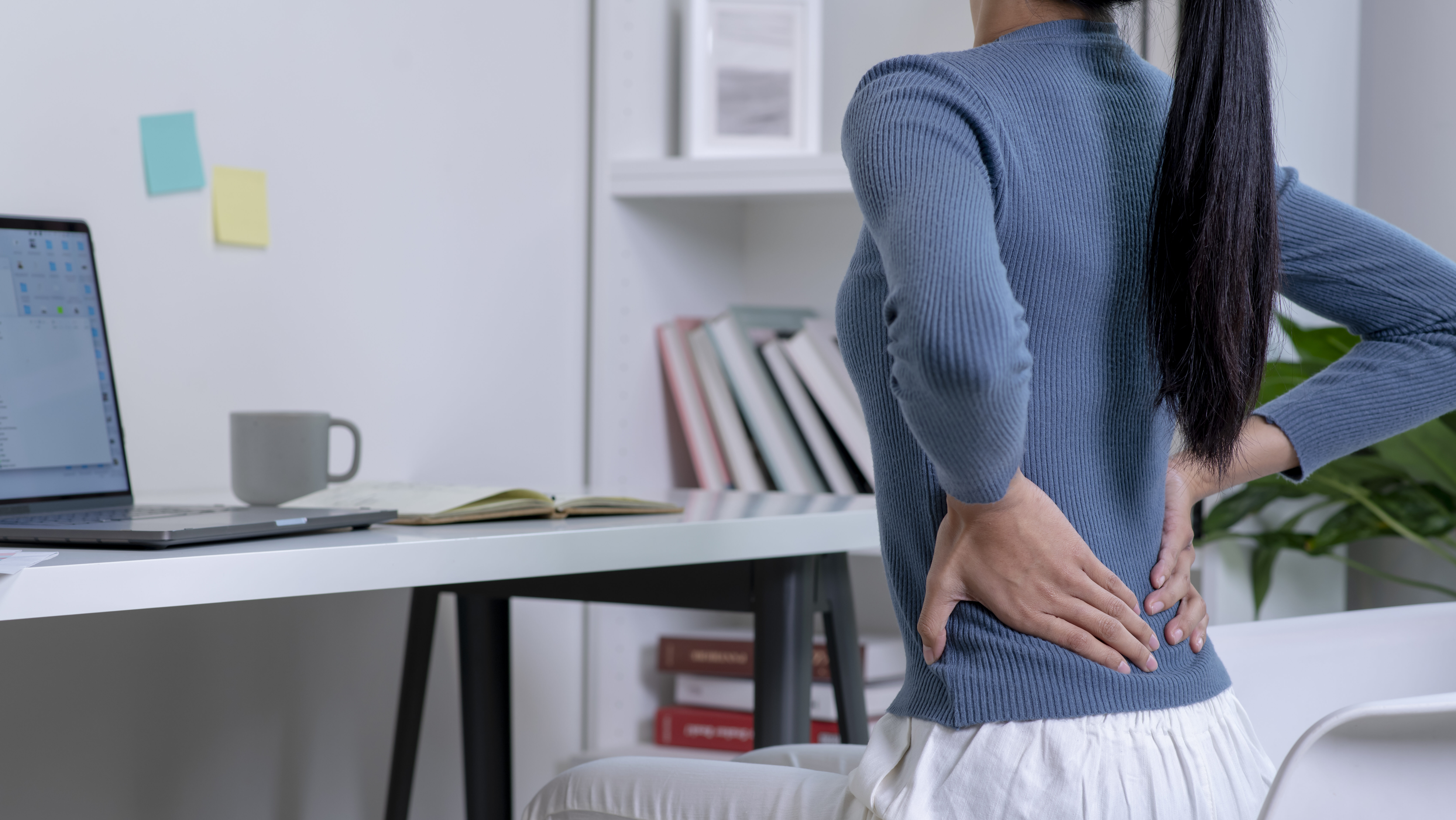 woman with back pain e1699554108735